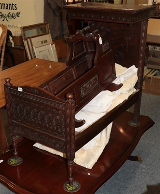 Lot 1242 - Decorative carved oak dolls half tester bed with bedding and drapes, 88cm by 52cm by 86cm; and...