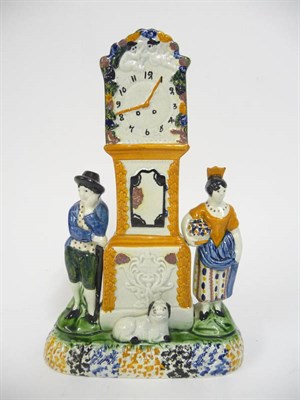 Lot 99 - A Pratt Type Pottery Money Box, circa 1800, as a longcase clock flanked by a gardener and his...