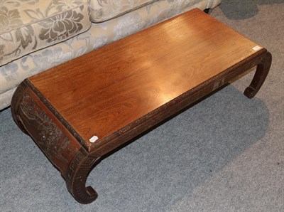 Lot 1248 - A Chinese coffee table with carved ends, 120cm by 48cm by 32cm high