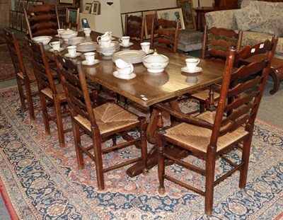 Lot 1252 - A set of eight oak ladderback dining chairs including two carver armchairs