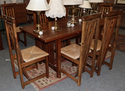 Lot 1256 - An Arts & Crafts style pine dining table, 165cm by 85cm by 78cm high, with ten matching chairs (11)
