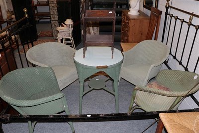 Lot 1260 - Four Lloyd Loom style green painted wicker tub chairs, a similar occasional table, and a poker work