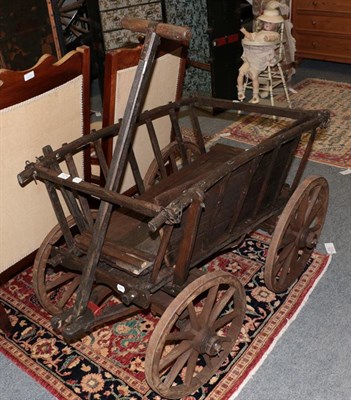Lot 1274 - A provincial wooden cart with iron shod wheels, 117cm by 75cm by 75cm