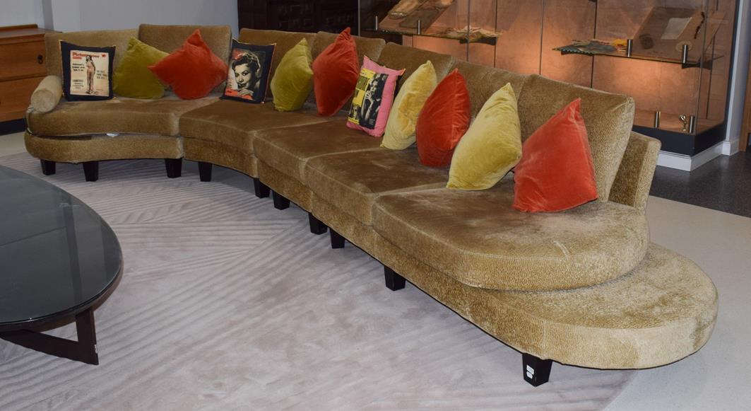 Lot 1303 - A Roche Bobois French curved sofa in gold crushed velvet, 540cm wide by 225cm deep by 167cm