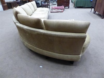 Lot 1303 - A Roche Bobois French curved sofa in gold crushed velvet, 540cm wide by 225cm deep by 167cm