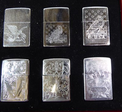 Lot 6 - ~ Two collectors display cases each containing forty Zippo lighters over two layers, US Navy,...