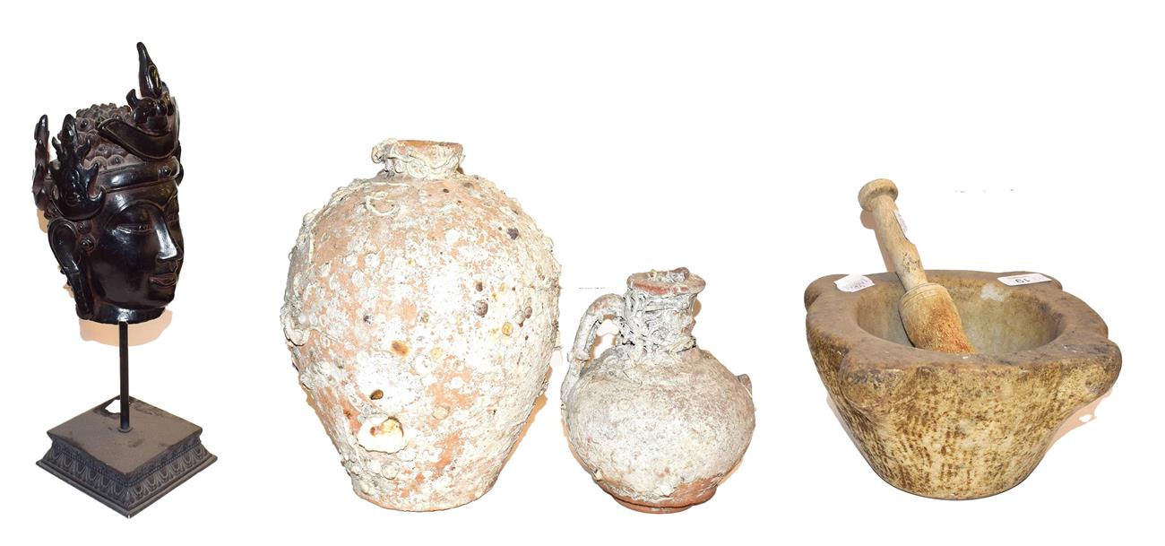 Lot 19 - ~ A white marble mortar with wooden pestle, two shipwrecked terracotta vessels and a composite...