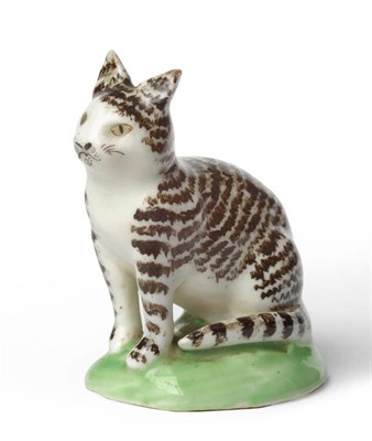 Lot 109 - A Rare Lowestoft Porcelain Figure of a Cat, circa 1780, seated with black stripe markings on a...