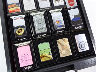 Lot 22 - ~ A collection of Zippo lighters, various themes (3 trays)