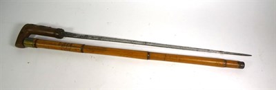 Lot 28 - ~ Two bamboo sword sticks, two other sword sticks including one with a tigers eye pommel,...