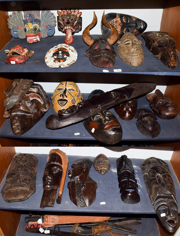 Lot 40 - ~ A quantity of souvenir tribal masks from Africa and Malaysia (on 3 shelves)