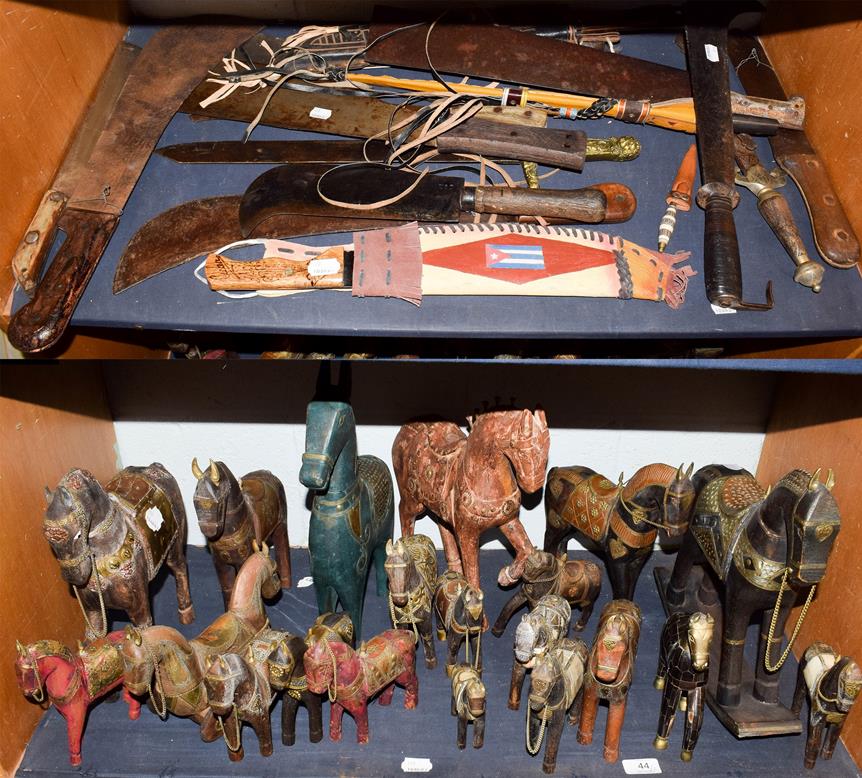 Lot 44 - ~ Two bill hooks, eleven machetes, two copy swords and a quantity of painted wood and other...