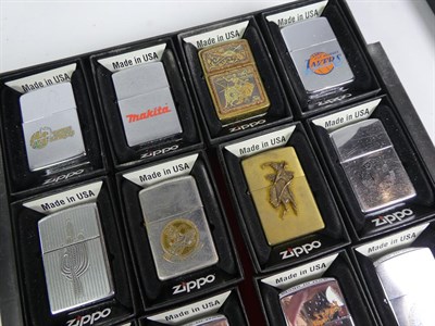 Lot 49 - ~ A collection of Zippo lighters including advertising and brass examples (3 trays)
