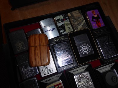 Lot 50 - ~ A collection of Zippo lighters including advertising examples (3 trays)