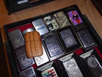 Lot 50 - ~ A collection of Zippo lighters including advertising examples (3 trays)