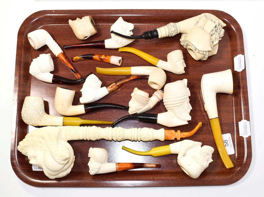 Lot 58 - ~ A collection of Meerschaum pipes, one large example elaborately formed as a Turk and also...
