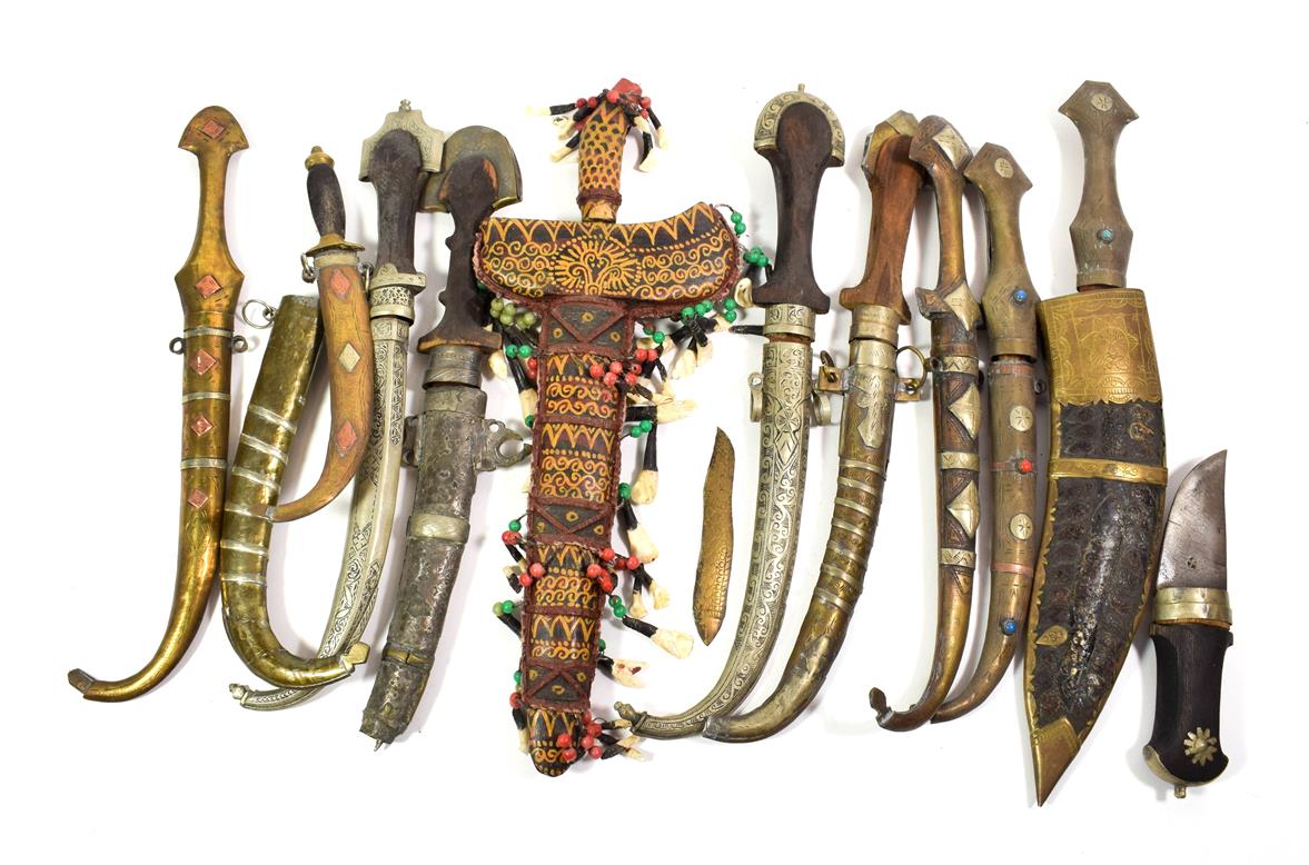 Lot 66 - ~ A collection of mainly Indian kinjhals and daggers including some with metal mounted scabbards; a