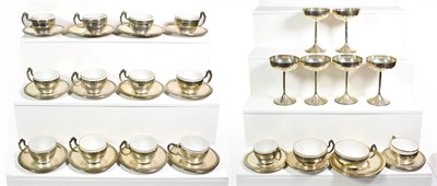 Lot 72 - ~ Fourteen Spanish silver coffee cups and saucers with opaque glass liners, stamped Baxeda 916/000.