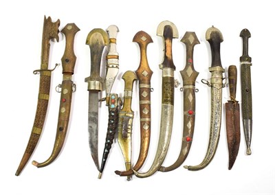 Lot 73 - ~ A quantity of Indian metal mounted kinjhals in scabbards and a horn scabbard with turquoise...