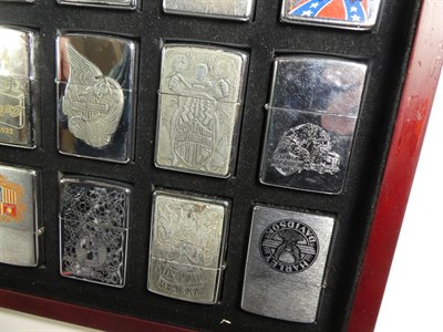 Lot 95 - ~ Six collectors cases containing 105 Zippo lighters, including Elvis Presley, Beatles, Harley...