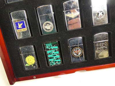 Lot 95 - ~ Six collectors cases containing 105 Zippo lighters, including Elvis Presley, Beatles, Harley...