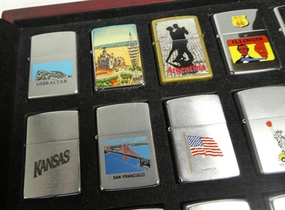 Lot 96 - ~ A quantity of Zippo lighters, some in collectors tins (2 display cases and 2 trays)