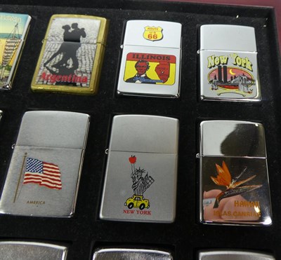 Lot 96 - ~ A quantity of Zippo lighters, some in collectors tins (2 display cases and 2 trays)