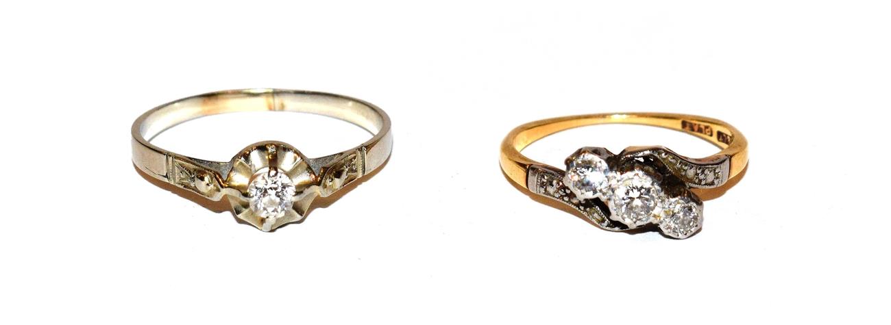 Lot 100 - ~ A diamond three stone twist ring, the graduated round brilliant cut diamonds in white claw...