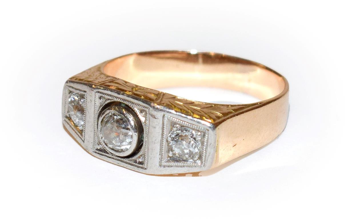 Lot 102 - ~ A diamond three stone ring, the graduated old cut diamonds in white claw and rubbed over...
