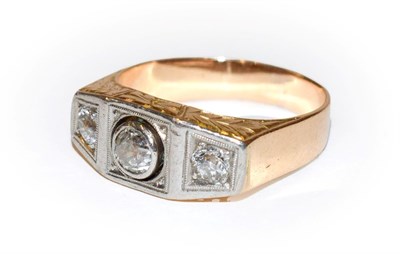 Lot 102 - ~ A diamond three stone ring, the graduated old cut diamonds in white claw and rubbed over...
