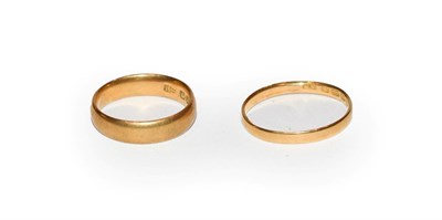 Lot 120 - A 22 carat gold band ring, finger size K; and another 22 carat gold band ring, out of shape