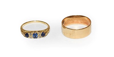 Lot 129 - An 18 carat gold band ring, finger size Q; and a sapphire and diamond ring, stamped '18CT',...
