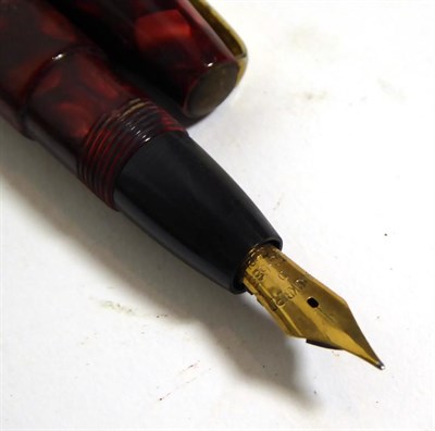 Lot 143 - A Swan Blackbird fountain pen with nib stamped 14C, a Mabie, Todd & Co. Ltd pencil, a Burnham...