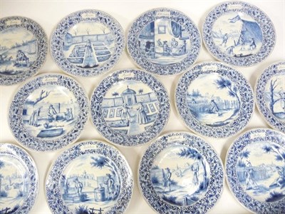 Lot 122 - A Set of Twelve Delft Calendar Plates, in 18th century style, painted in blue with figures at...