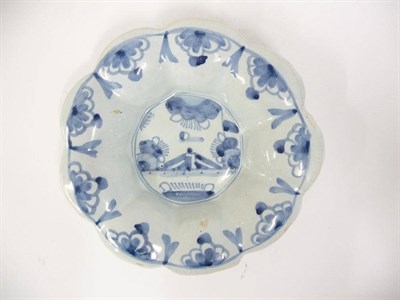 Lot 123 - A Delft Lobed Circular Dish in Late 17th Century Style, painted in blue with a fenced garden within