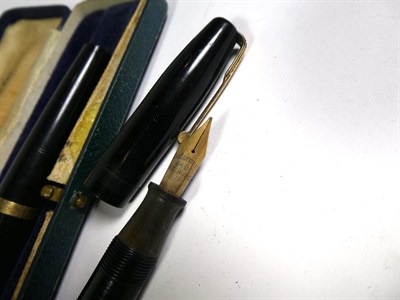 Lot 172 - A Waterman's fountain pen with nib stamped 14ct, a Conway 106 fountain pen, a Golden Sovereign...