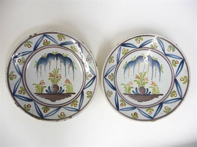 Lot 125 - A Pair of Delft Dishes, mid 18th century, painted in blue, green, red and manganese with a tree...