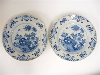 Lot 126 - A Pair of Dutch Delft Dishes, mid 18th century, painted in blue chinoiserie foliage in a fenced...