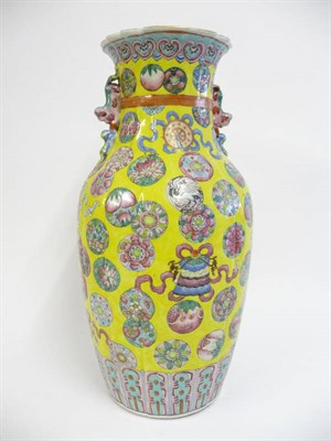 Lot 129 - A Chinese Porcelain Baluster Vase, 19th century, ribbon tied fluted form with mythical beast...