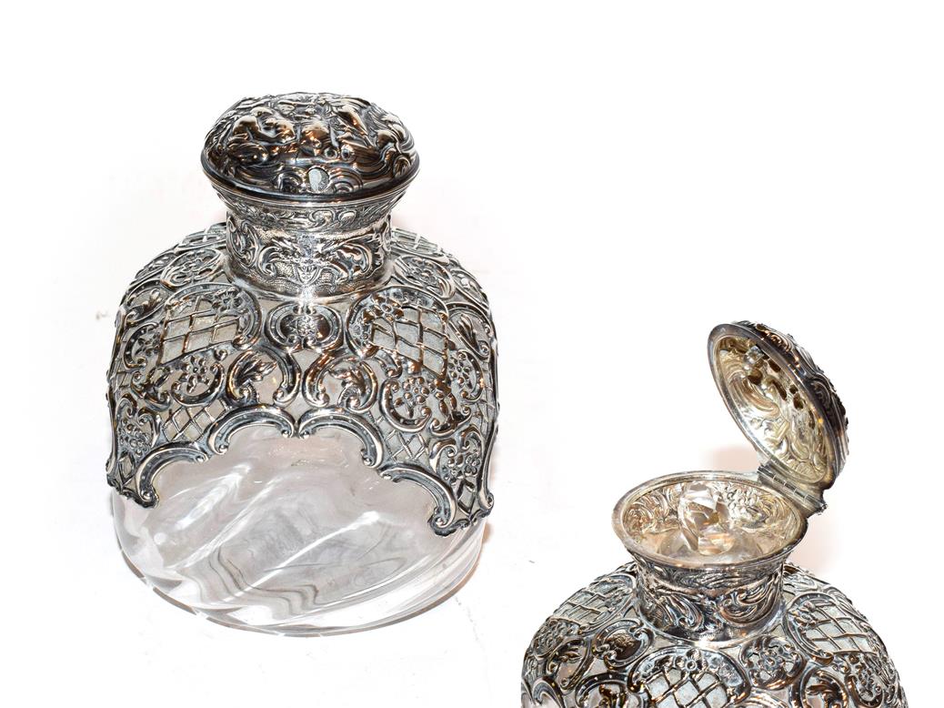 Lot 225 - A Victorian silver-mounted glass scent-bottle, by William Comyns, London, 1894, the shaped...