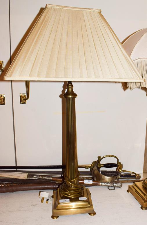 Lot 251 - A pair of brass table lamps of fluted column form, raised on square stepped bases over button feet