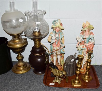 Lot 253 - A pair of coloured bisque figures, two oil lamps, painted lacquer bucket, Romanesque oil lamp...