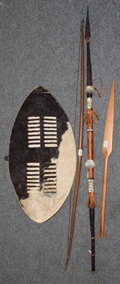 Lot 256 - Zulu hide dance shield, two modern spears and a self bow