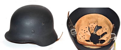 Lot 261 - A copy of a German Third Reich M40 army helmet, with dark green/grey  'Rauhlack' finish,...