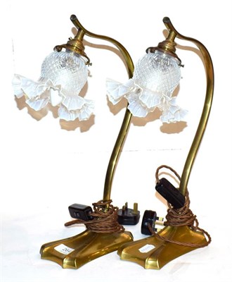 Lot 264 - A pair of brass scoll formed table lamps with opaline glass shades