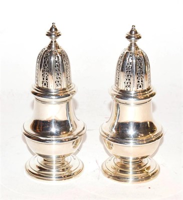 Lot 270 - A pair of Elizabeth II silver baluster form pepper casters by William Comyns & Sons Ltd....