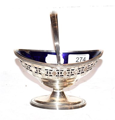 Lot 274 - An Edwardian silver swing handled sugar basket with Bristol blue glass liner by Thomas Bradbury...