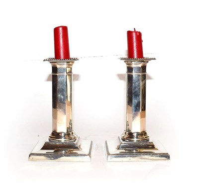 Lot 276 - A pair of George V weighted silver dwarf candlesticks by Hawksworth, Eyre & Co Ltd. With detachable