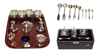 Lot 283 - A collection of silver condiment Items, including: a set of four fluted salt-cellars on ball...