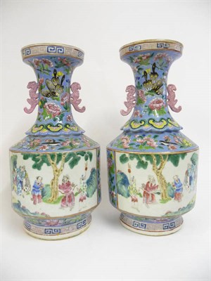 Lot 140 - A Pair of Chinese Porcelain Vases, 19th century, the trumpet necks with mythical beast handles...